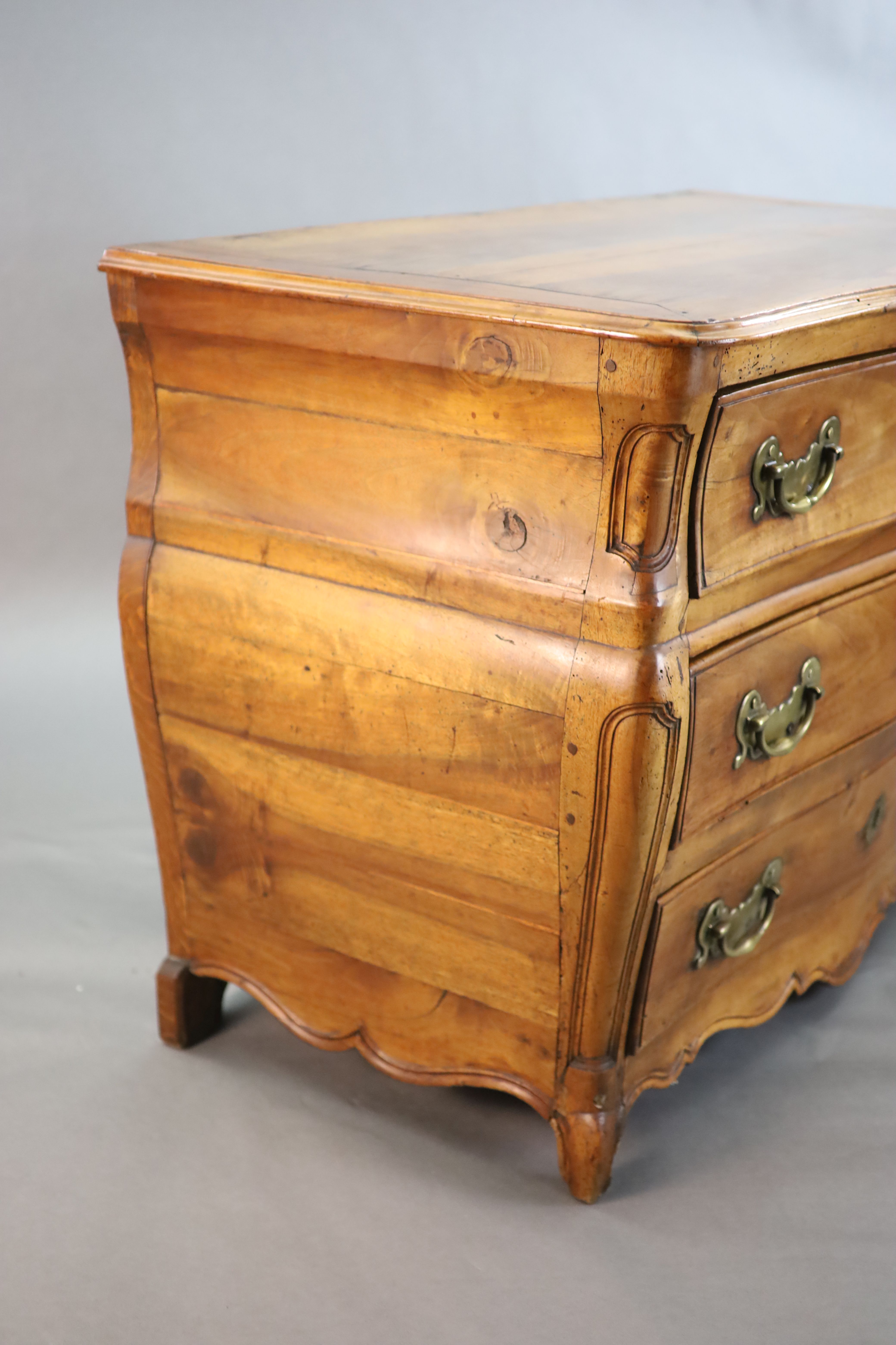 A 19th century Continental walnut serpentine commode, W.3ft 10in. D.2ft 1in. H.2ft 8in.